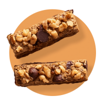 Two fudgy chocolate bars topped with semi-sweet and butterscotch morsel against an orange gradient circle.