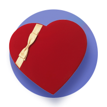 A red heart shaped chocolate box with a white ribbon against a royal blue gradient circle.