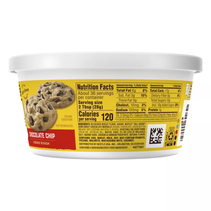 Left side view of a white tub with a yellow and red label, nutrition facts, and scoop & bake instructions beside a chocolate chip cookie.